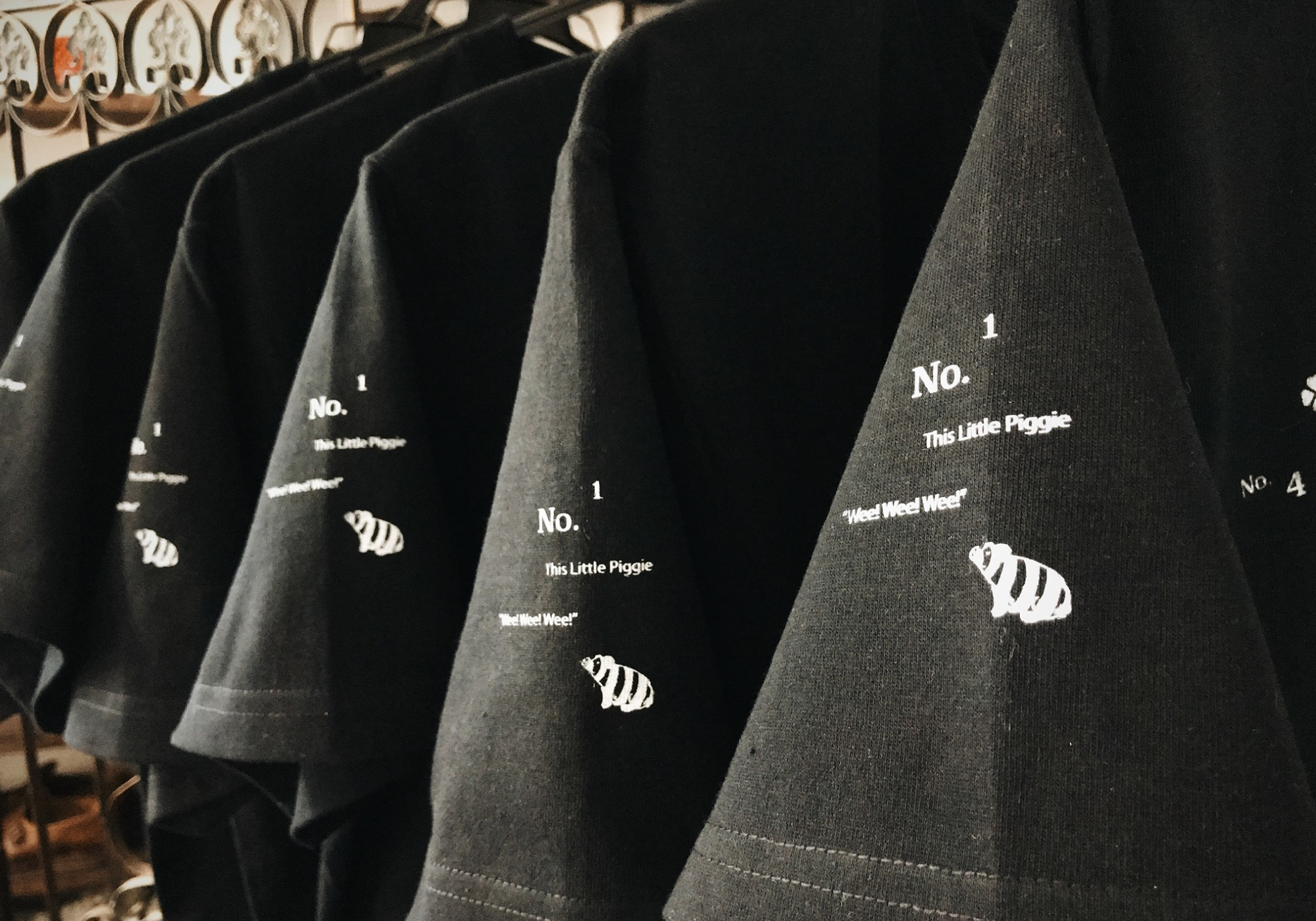 白いブタがプリントされた黒のTシャツ